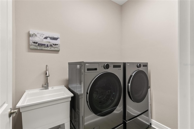 laundry room featuring a sink, laundry area, and washing machine and dryer