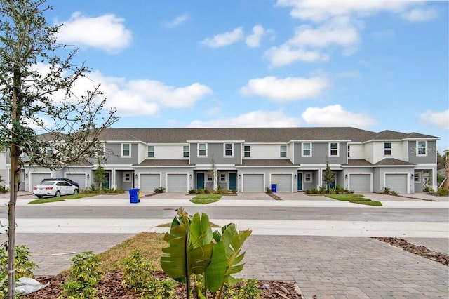 exterior space with a residential view, driveway, and a garage