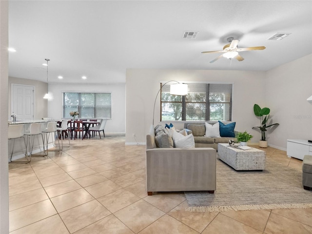 tiled living room featuring a wealth of natural light and ceiling fan