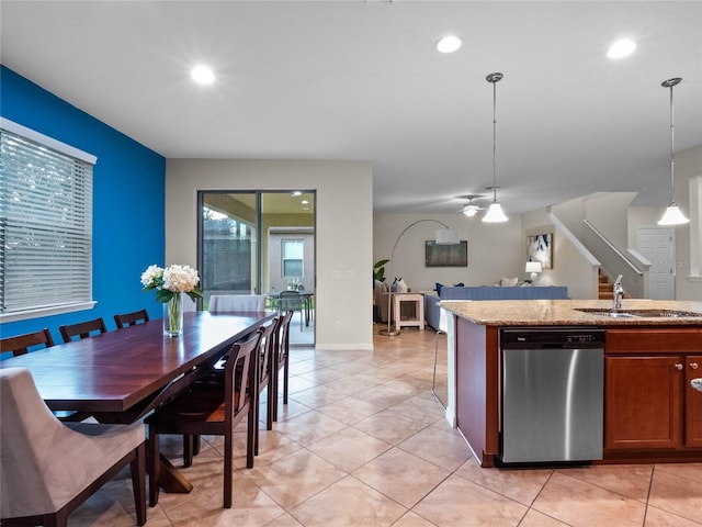 kitchen featuring sink, decorative light fixtures, stainless steel dishwasher, and light tile patterned flooring