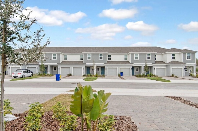 exterior space with a garage, a residential view, and driveway