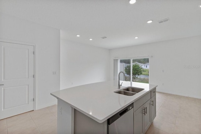 kitchen featuring a center island with sink, recessed lighting, a sink, light countertops, and stainless steel dishwasher