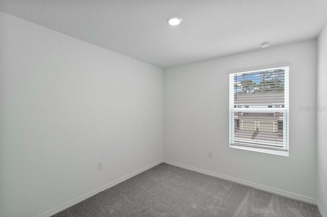 unfurnished room featuring baseboards and carpet floors