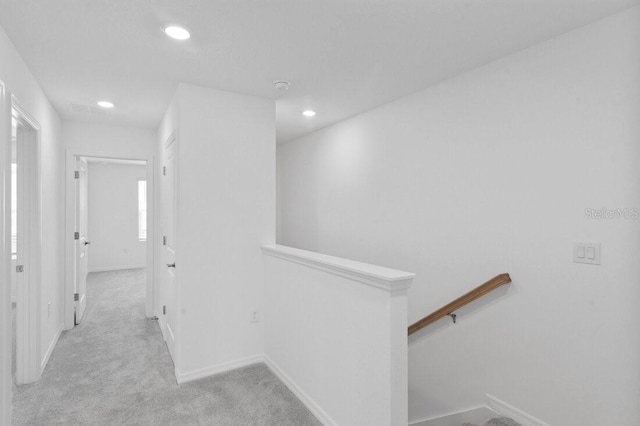 hall with an upstairs landing, recessed lighting, baseboards, and carpet floors