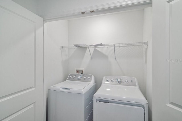 laundry room featuring washer and dryer and laundry area