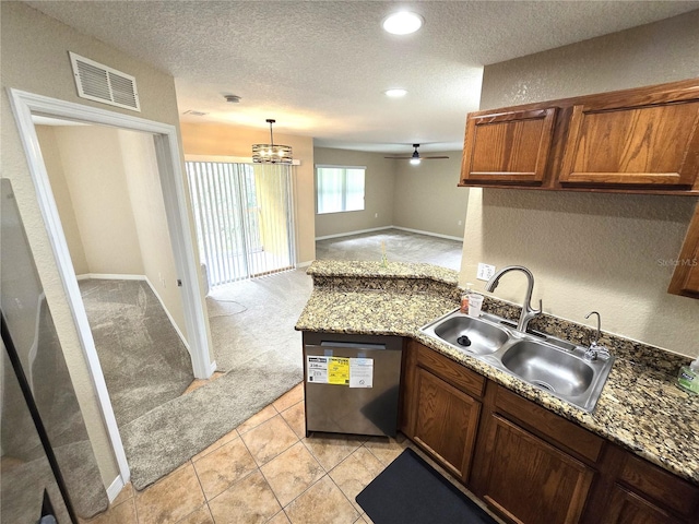 kitchen with dishwasher, sink, ceiling fan with notable chandelier, light colored carpet, and stone counters