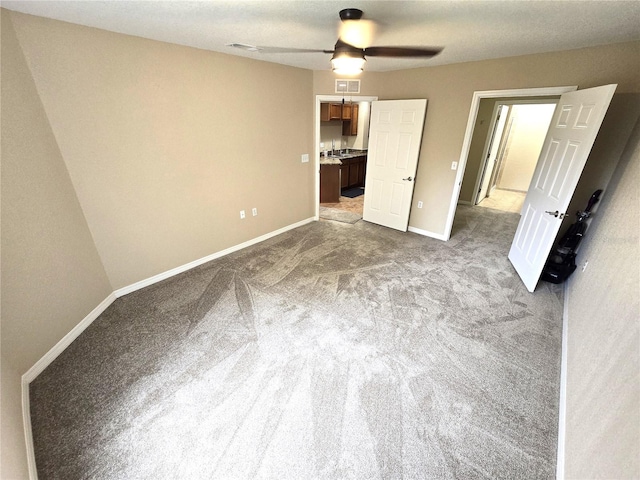 unfurnished bedroom featuring ceiling fan and carpet floors