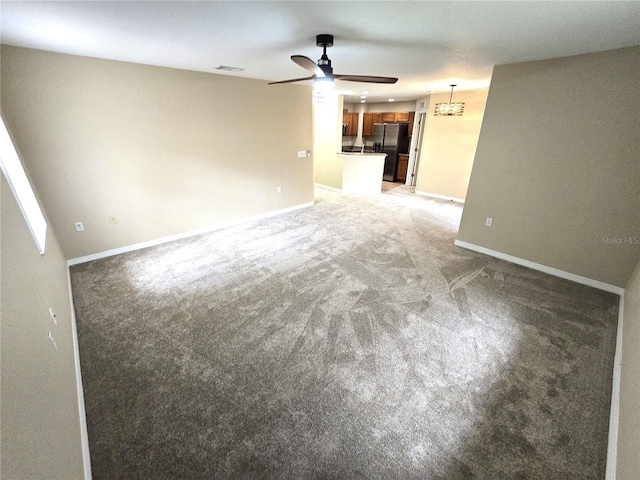 unfurnished living room with ceiling fan and carpet floors