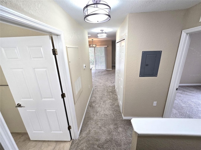 hall with light colored carpet and electric panel