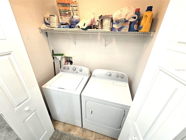 washroom featuring light tile patterned flooring and washer and dryer