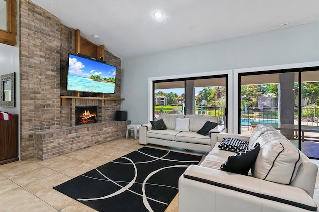 tiled living room with plenty of natural light, lofted ceiling, and a brick fireplace