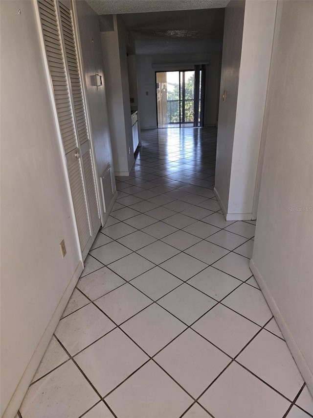 corridor with light tile patterned floors