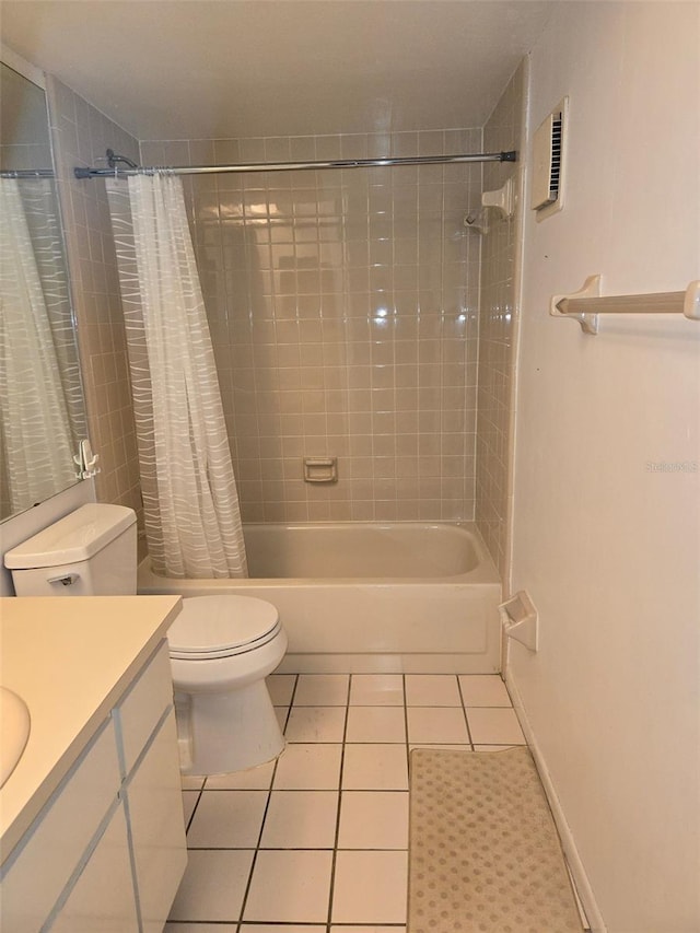 full bathroom featuring tile patterned floors, vanity, shower / bath combination with curtain, and toilet