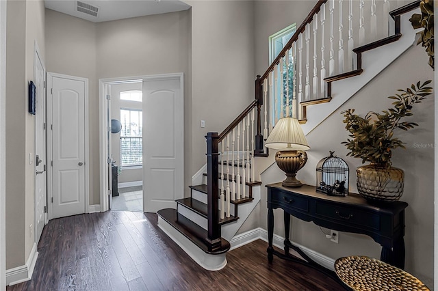 entrance foyer with a high ceiling and dark wood-type flooring