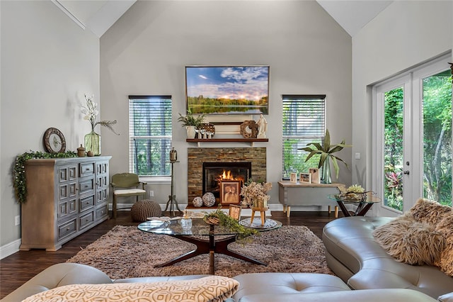 living room with a fireplace, dark hardwood / wood-style floors, and high vaulted ceiling