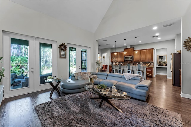 living room featuring dark wood-type flooring, french doors, and high vaulted ceiling