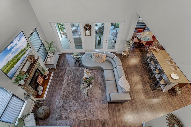 living room with french doors, sink, and dark wood-type flooring