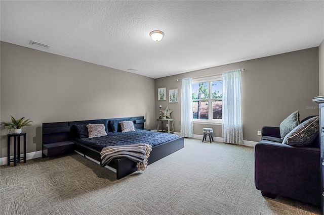 carpeted bedroom with a textured ceiling