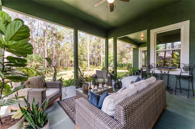 sunroom / solarium featuring ceiling fan