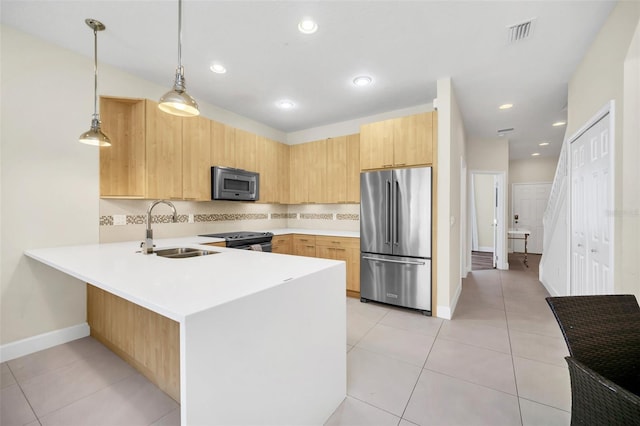 kitchen featuring appliances with stainless steel finishes, kitchen peninsula, pendant lighting, light brown cabinetry, and sink