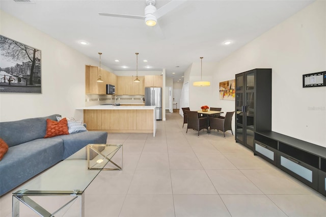 living room featuring sink and light tile patterned floors