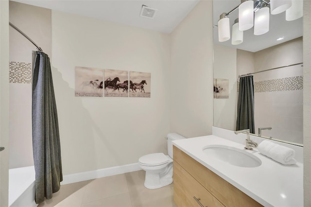 bathroom featuring vanity, tile patterned flooring, and toilet