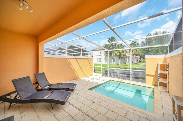 view of pool with a lanai and a patio area