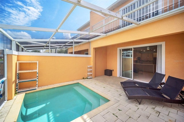 view of swimming pool with a lanai and a patio area