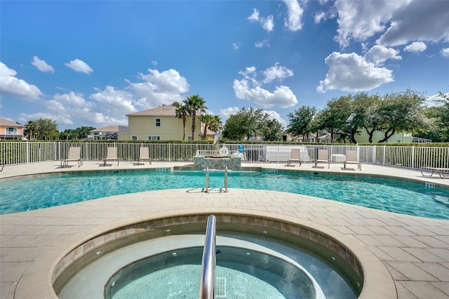 view of pool featuring a community hot tub and a patio area