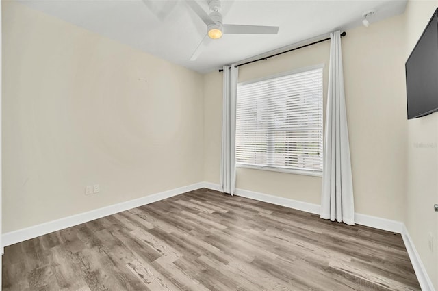 empty room featuring ceiling fan and hardwood / wood-style flooring