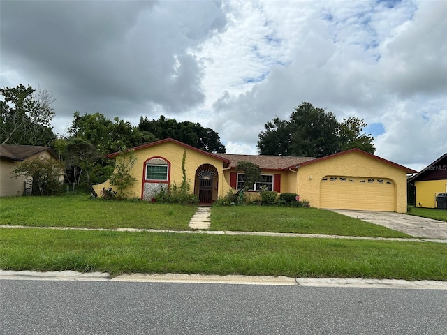 view of front of house with a front yard and a garage