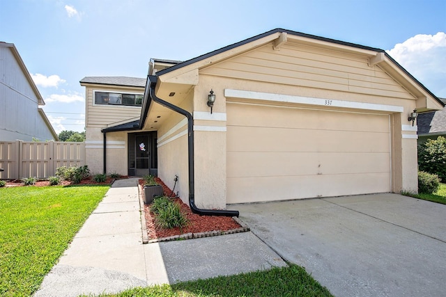 view of front facade featuring a garage and a front lawn