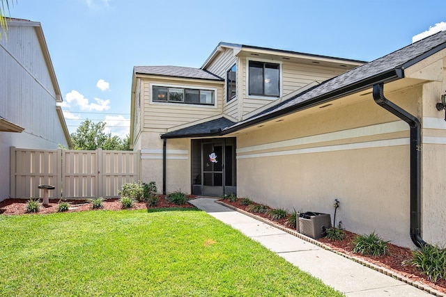 exterior space featuring central AC unit and a yard