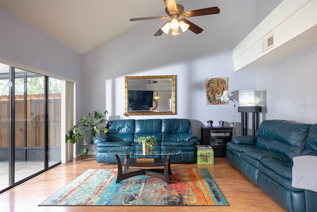 living room with vaulted ceiling, light hardwood / wood-style floors, and ceiling fan