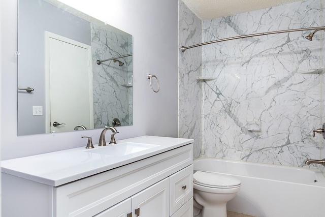 full bathroom with tiled shower / bath, vanity, and toilet