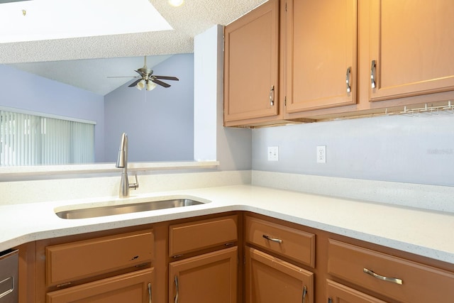 kitchen featuring sink, a textured ceiling, vaulted ceiling, and ceiling fan