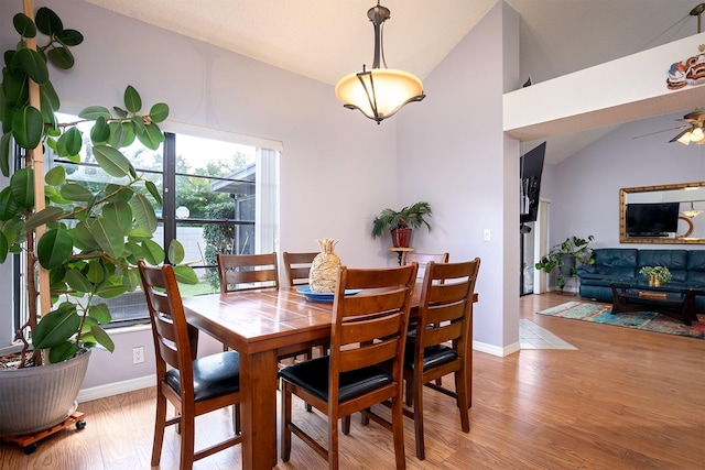 dining space with lofted ceiling, light hardwood / wood-style flooring, and ceiling fan