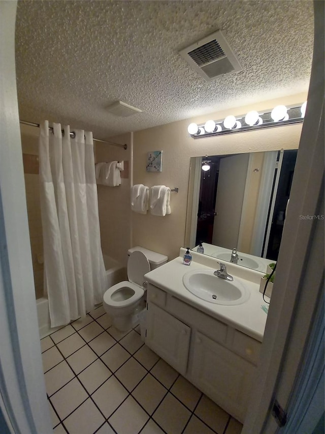 full bathroom featuring shower / bath combination with curtain, vanity, a textured ceiling, tile patterned floors, and toilet