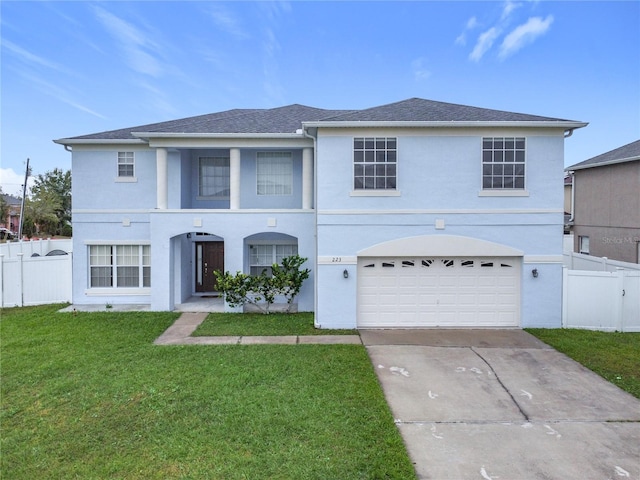 view of front of house featuring a garage and a front lawn