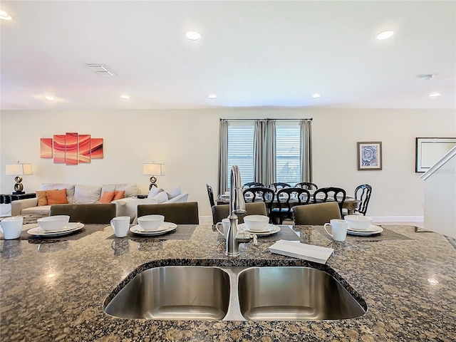 kitchen with dark stone countertops and sink