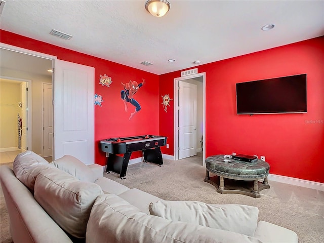 rec room featuring carpet floors and a textured ceiling