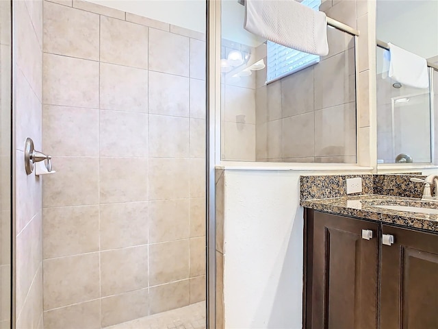 bathroom featuring walk in shower and vanity