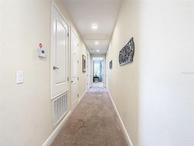 hallway with light colored carpet