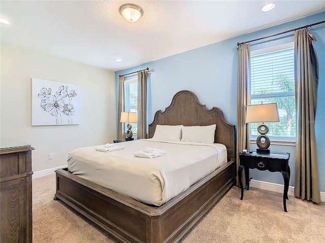 bedroom featuring light carpet