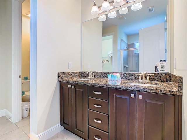 bathroom featuring walk in shower, tile patterned floors, vanity, and toilet