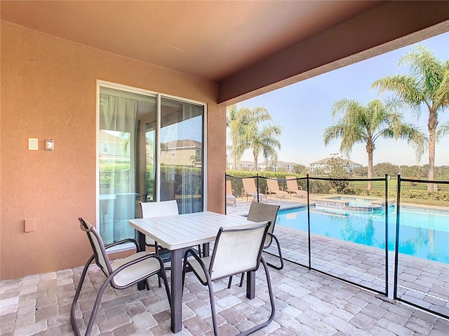 exterior space featuring an in ground hot tub and a patio