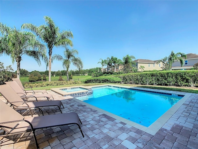 view of swimming pool with an in ground hot tub