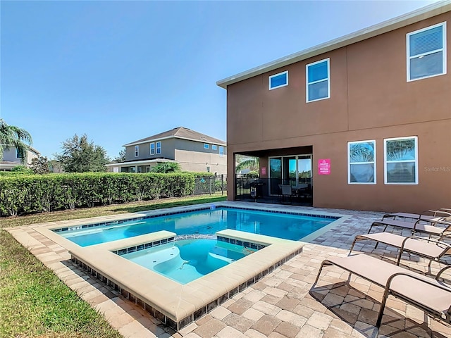 view of swimming pool featuring a patio and an in ground hot tub