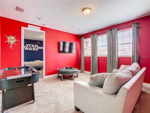 interior space featuring carpet and a textured ceiling