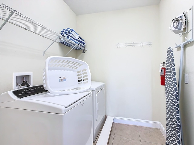 washroom with washing machine and dryer and light tile patterned floors